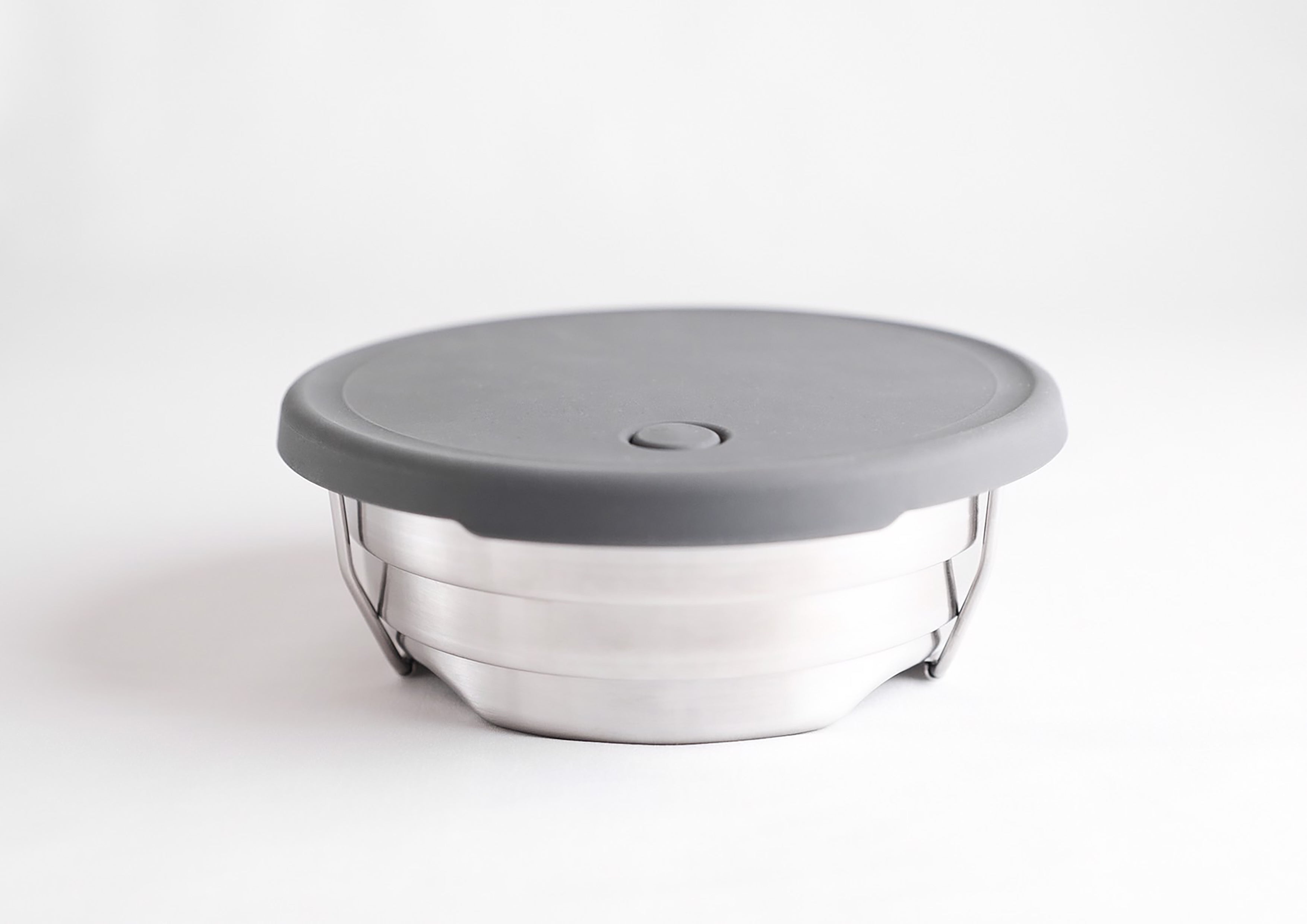 Collapsible steel camping pot compacts into a thin disc for easy carry